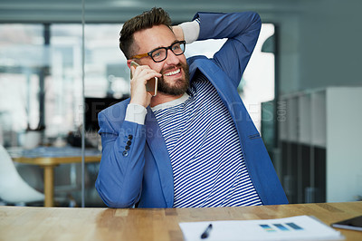 Buy stock photo Cropped shot of a young businessman talking on a cellphone in an office