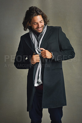 Buy stock photo Shot of a stylishly dressed man posing against a gray background in the studio