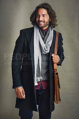 Buy stock photo Shot of a stylishly dressed man posing with a leather satchel in the studio