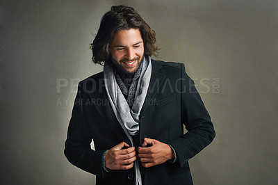 Buy stock photo Shot of a stylishly dressed man posing against a gray background in the studio