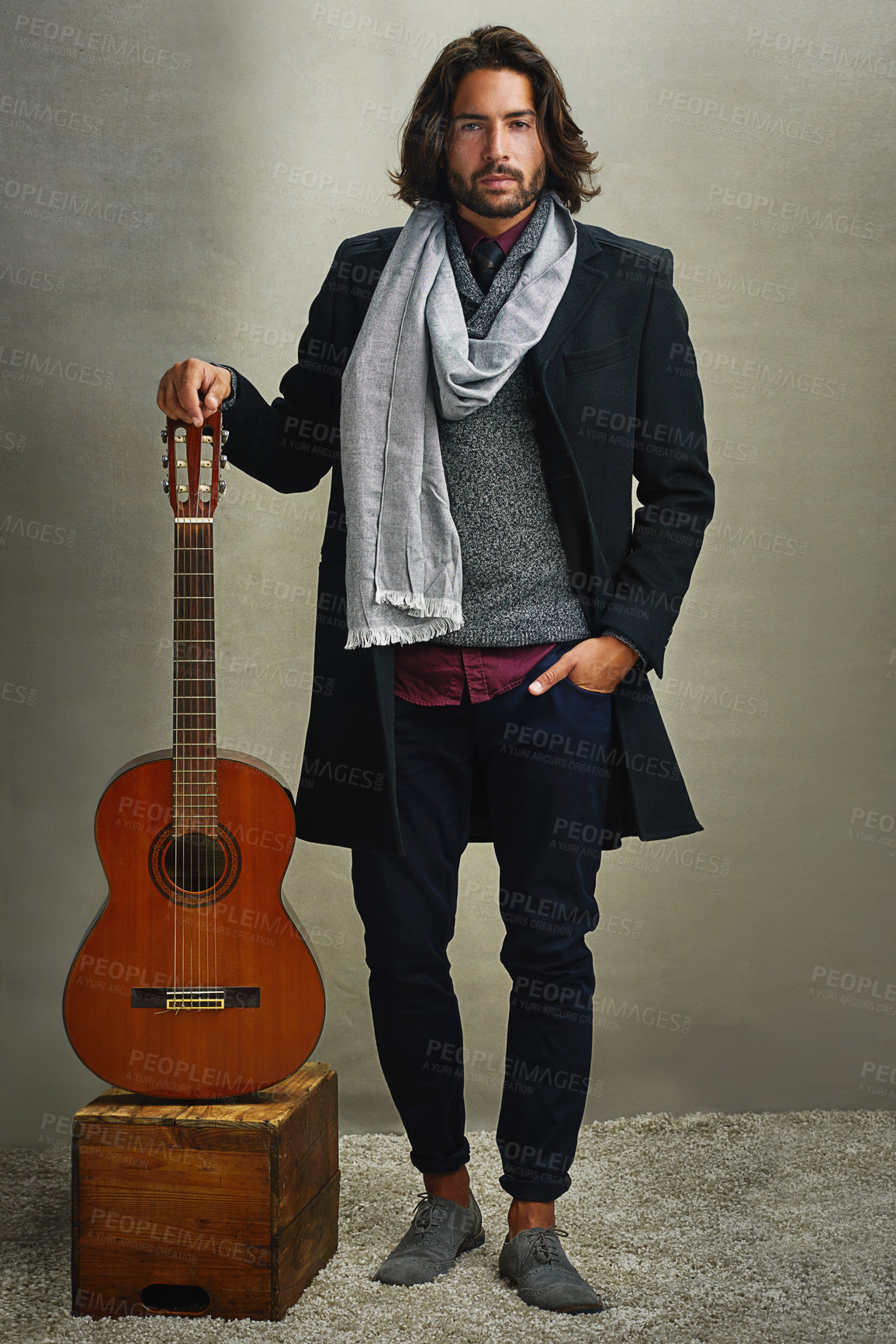 Buy stock photo Portrait of a stylishly dressed man posing with a guitar in the studio