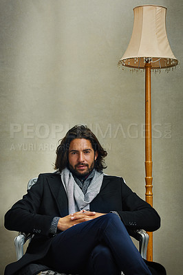 Buy stock photo Portrait of a stylishly dressed man sitting on a chair in the studio