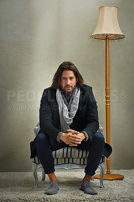 Buy stock photo Portrait of a stylishly dressed man sitting on a chair in the studio