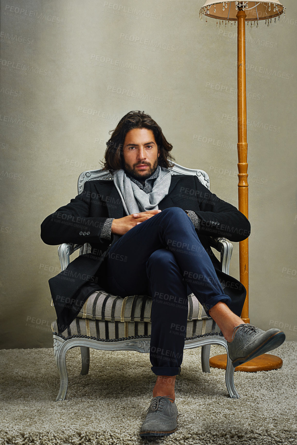 Buy stock photo Portrait of a stylishly dressed man sitting on a chair in the studio