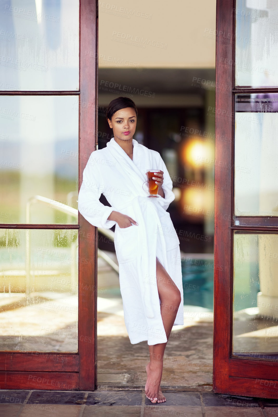 Buy stock photo Door, woman and portrait at spa with tea on holiday, relax and break for luxury and mindfulness. Female person, resort and thinking with herbal drink on vacation, trip and travel for wellness