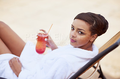 Buy stock photo Shot of an attractive young woman relaxing with a cocktail at a spa