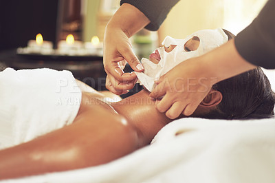 Buy stock photo Shot of a young woman receiving a beauty treatment with a mask at a spa