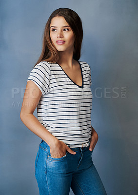 Buy stock photo Studio shot of an attractive young woman posing with her hands in her pockets