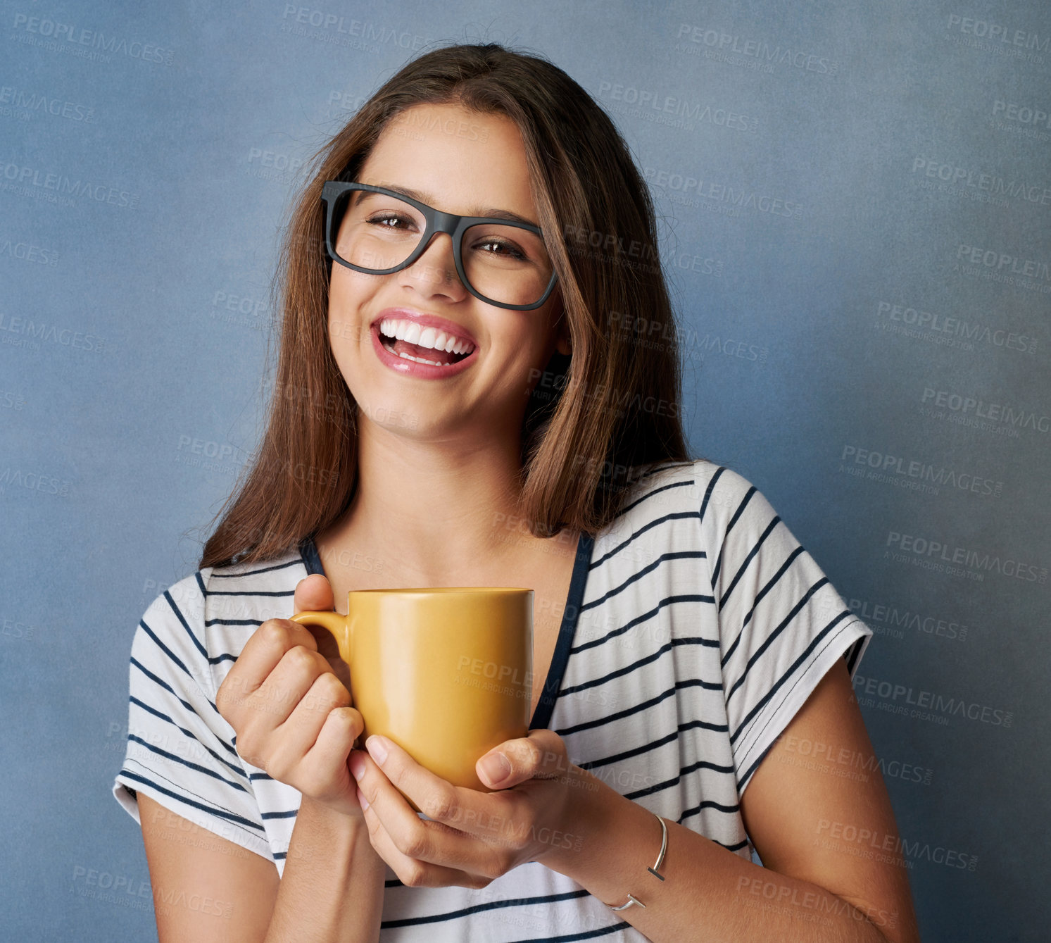 Buy stock photo Studio shot of an attractive young woman holding a coffee mug against a gray background