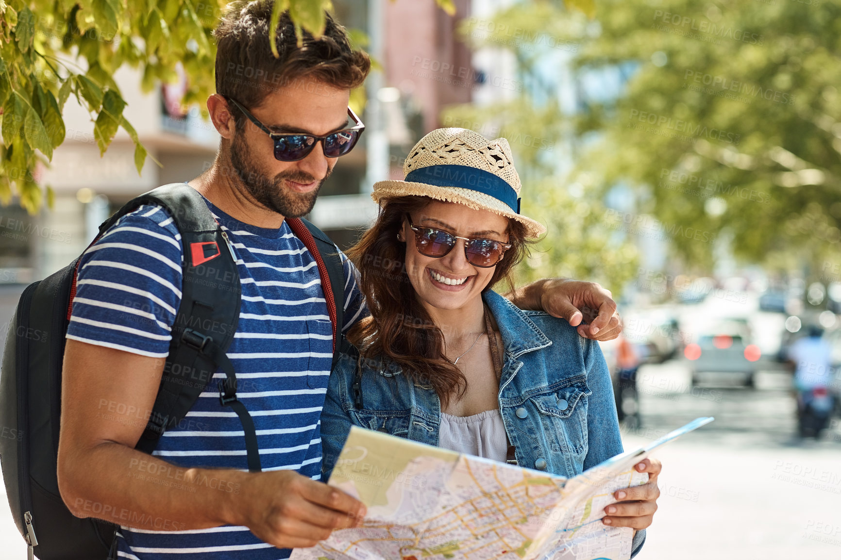 Buy stock photo Shot of a happy tourist couple using a map to explore a foreign city together
