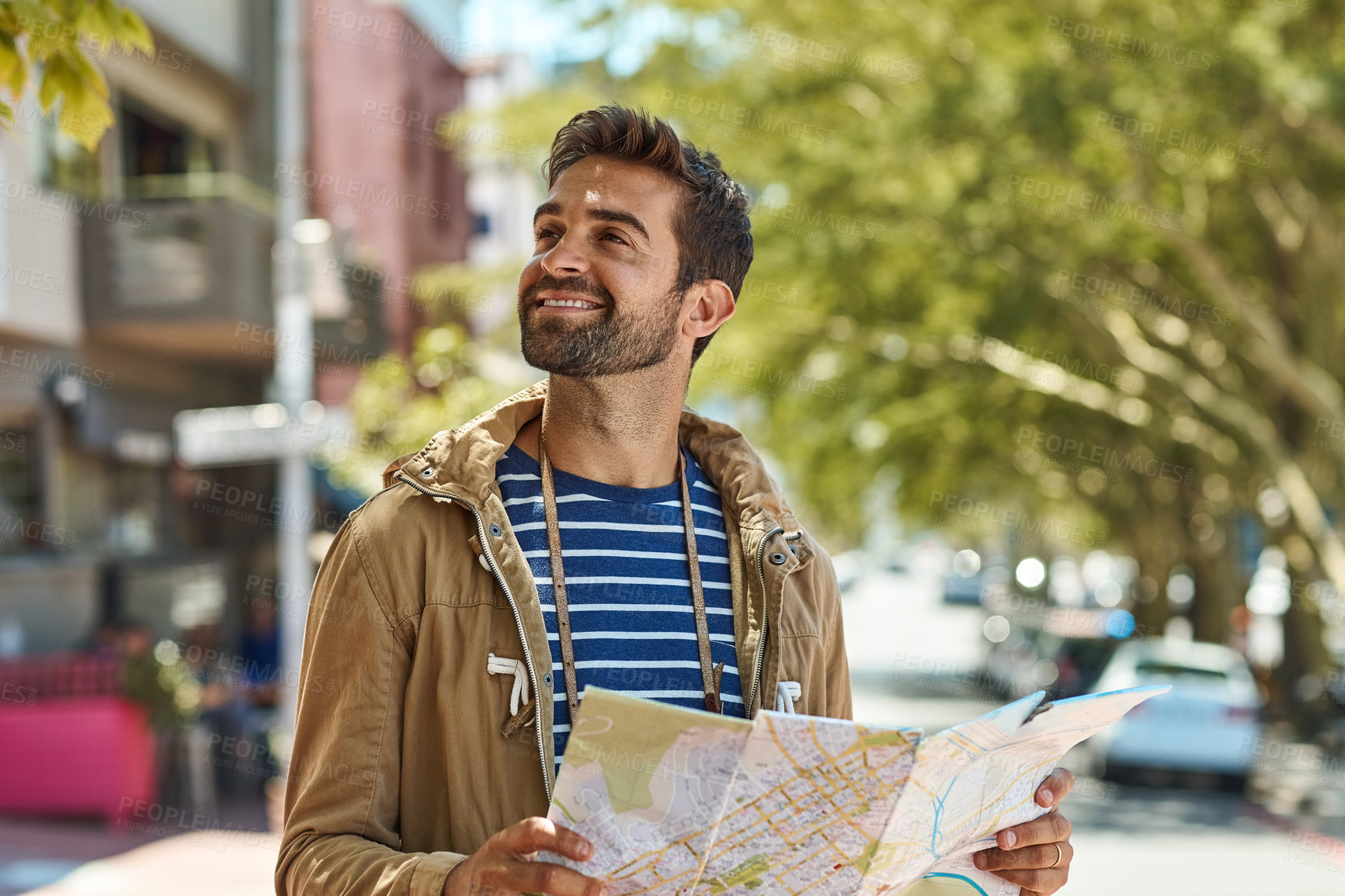 Buy stock photo Happy man, travel and city sightseeing in outdoor, map and urban vacation in Budapest. Male person, journey and explore town road for adventure, document and search chart for direction or navigation