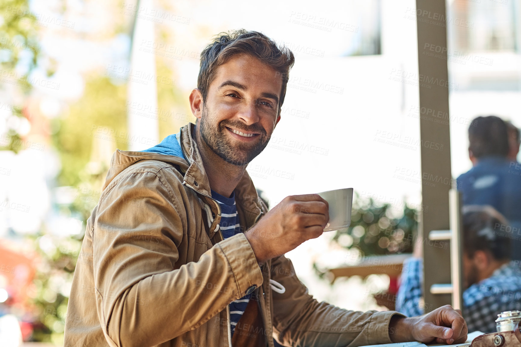Buy stock photo Portrait of a laid-back tourist enjoying a cup of coffee at a sidewalk cafe