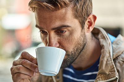 Buy stock photo Shot of a laid-back tourist enjoying a cup of coffee at a sidewalk cafe