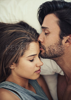 Buy stock photo Above, couple and affection with kiss, intimacy and love in home for bonding, relax and sleep on weekend. Woman, man and connection for marriage, commitment and partner  with happy, care and bedroom