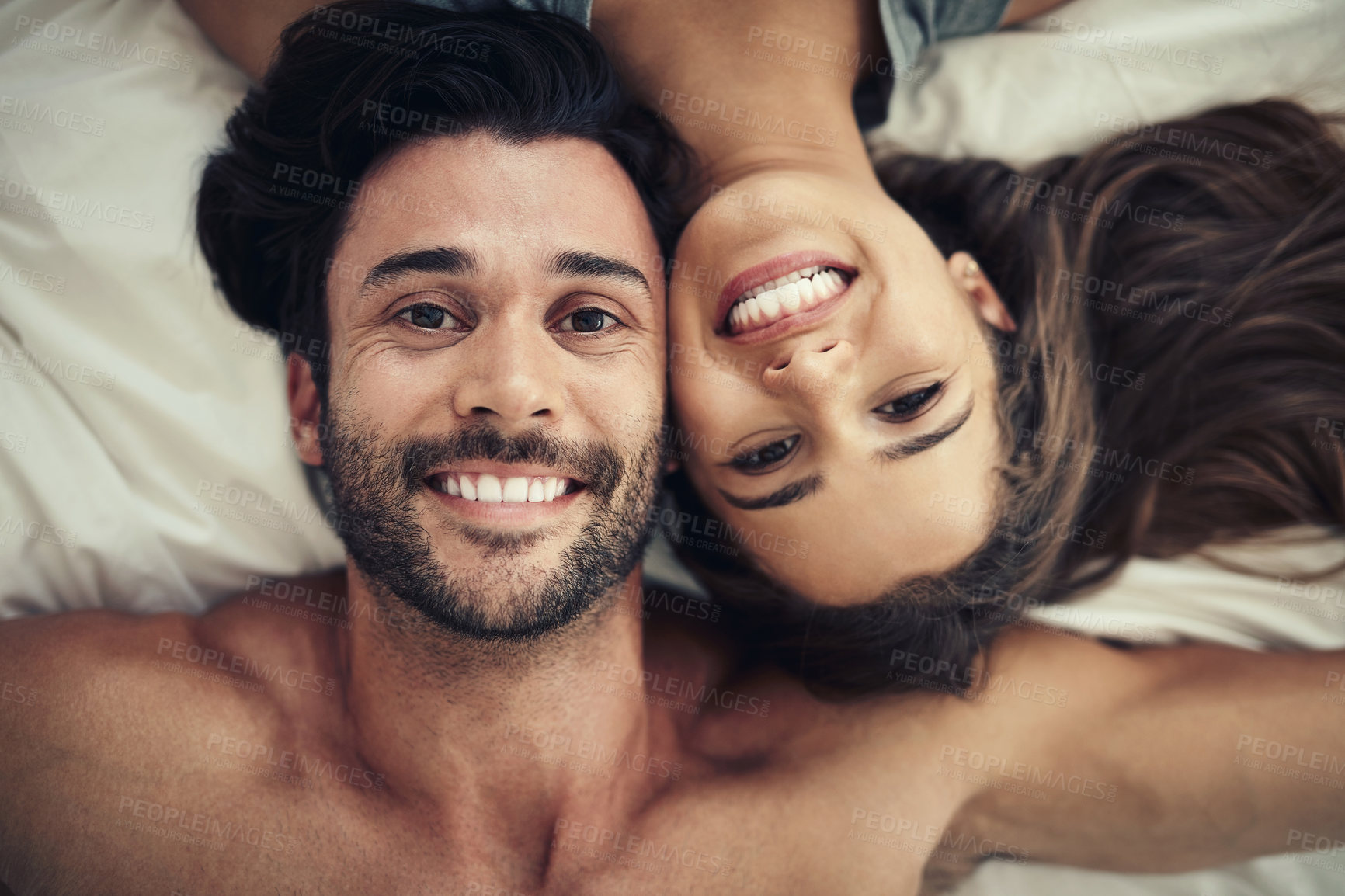 Buy stock photo Smile, portrait and couple on bed in home for relaxing morning on weekend together from above. Happy, love and face of young man and woman resting in bedroom for bonding and connection at house