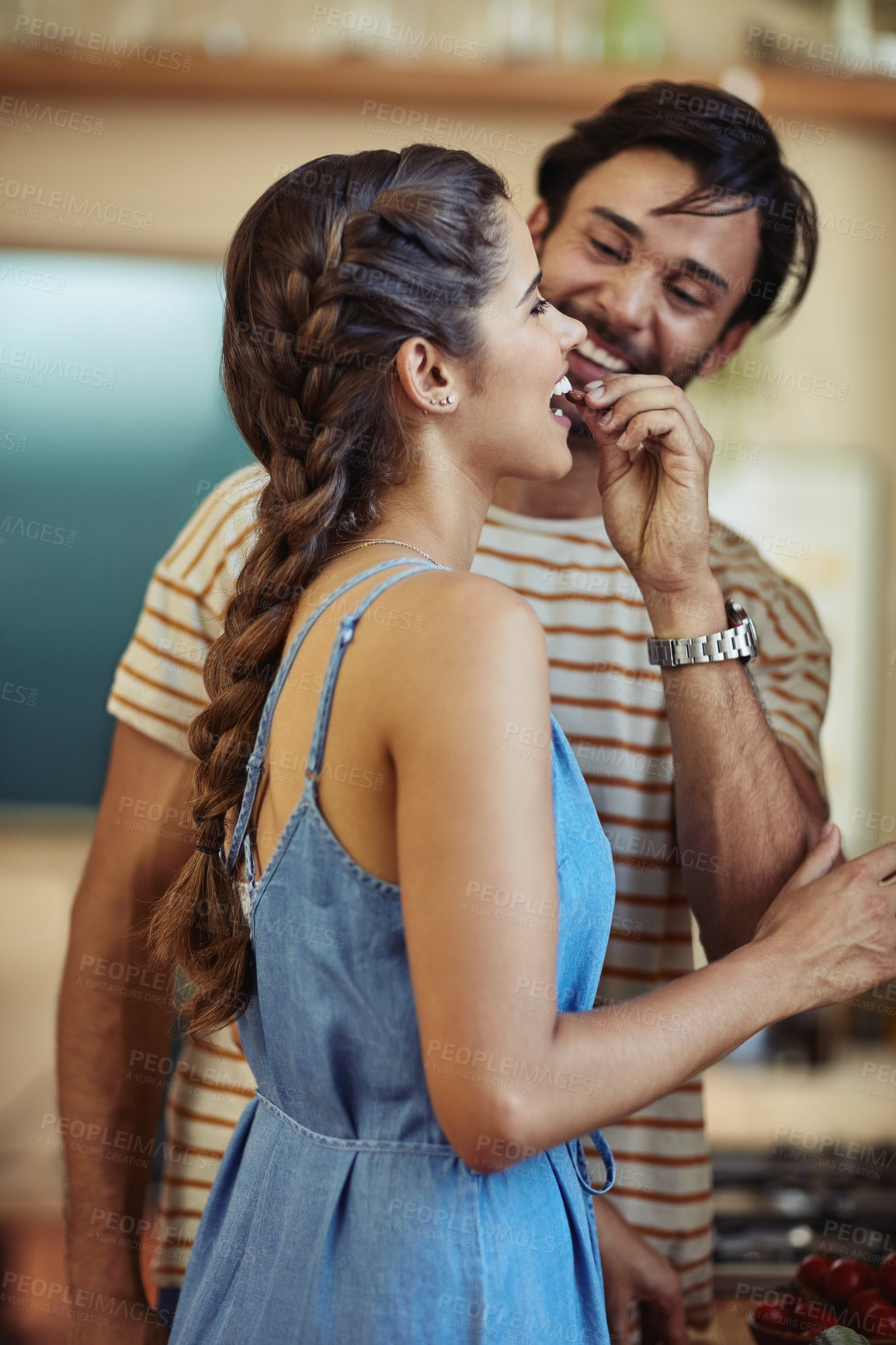 Buy stock photo Snack, eating and couple in kitchen, smile and romance for anniversary in house, date and together in morning. Commitment, man and woman with food and people in home, happy and calm in weekend