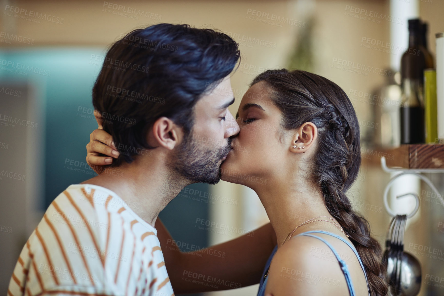 Buy stock photo Kiss, date and couple in kitchen, home and romance for anniversary in house, love and together in morning. Commitment, man and woman with embrace, peace and people in relationship and calm in weekend