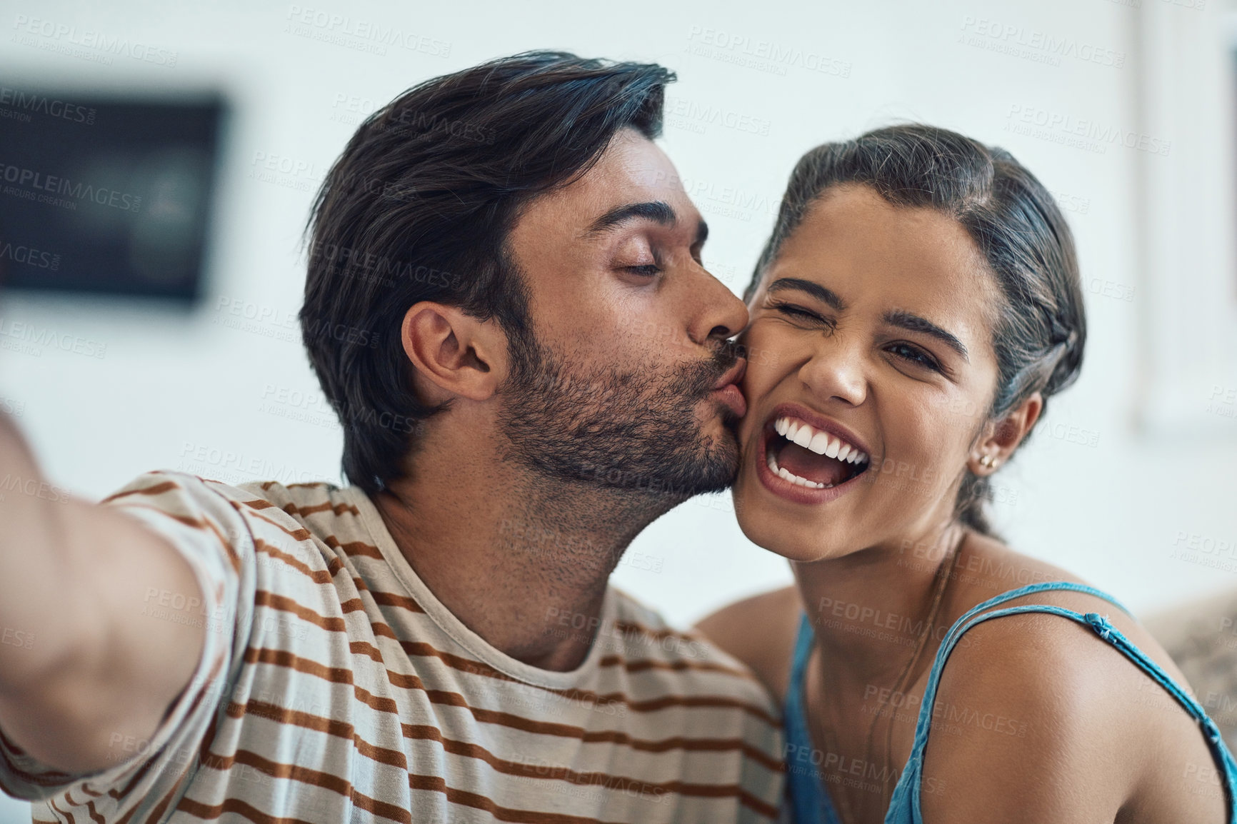 Buy stock photo Selfie, couple and kiss in house with love for relationship commitment, memory and compassion with care. Man, woman and photography together in home with soul connection, romance and bonding.