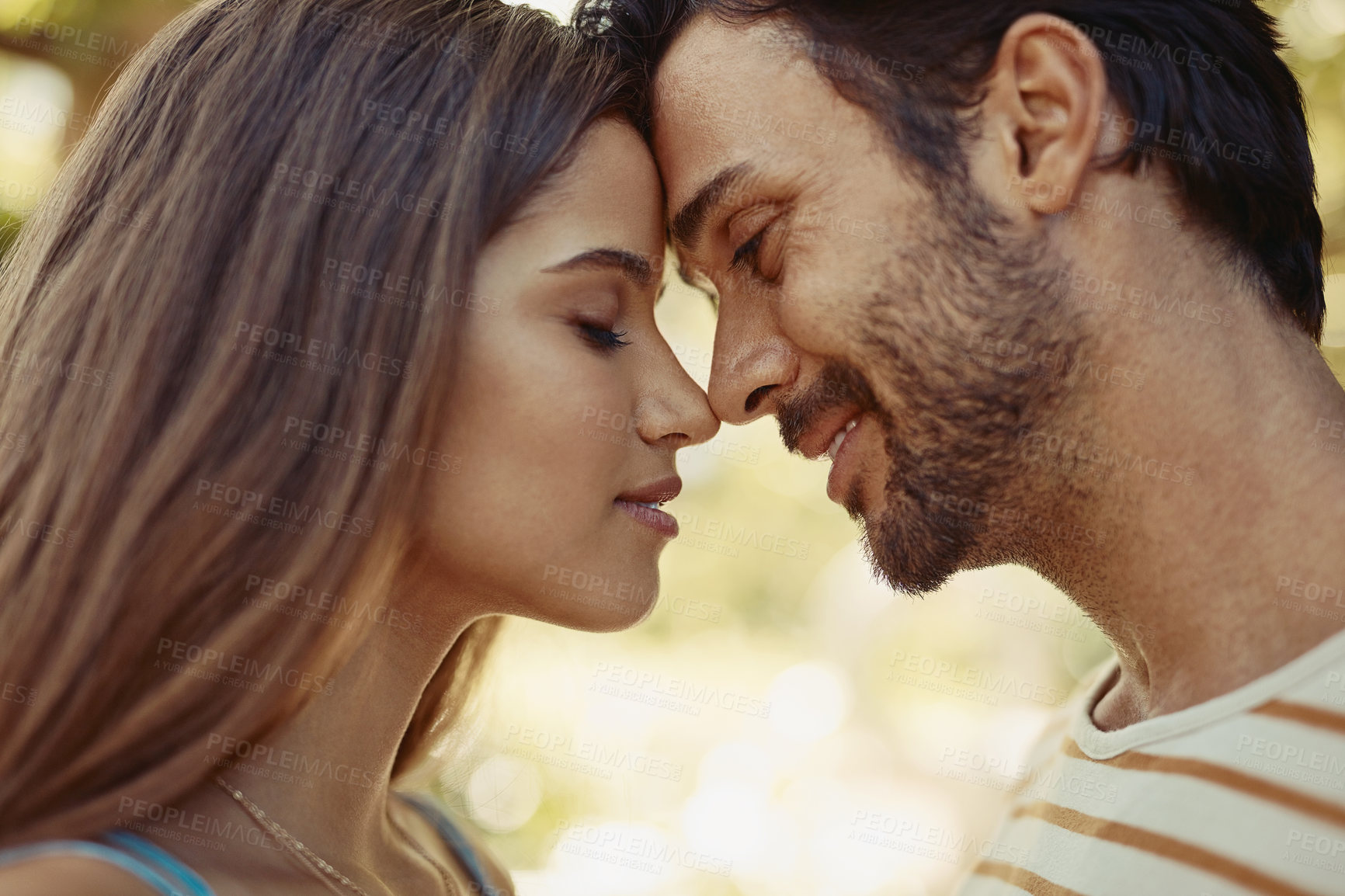 Buy stock photo Outdoor, couple and happy with forehead touch in park for bonding, love and affection in Spain. People, relationship and smile for support with care as lovers on break to relax, rest and embrace