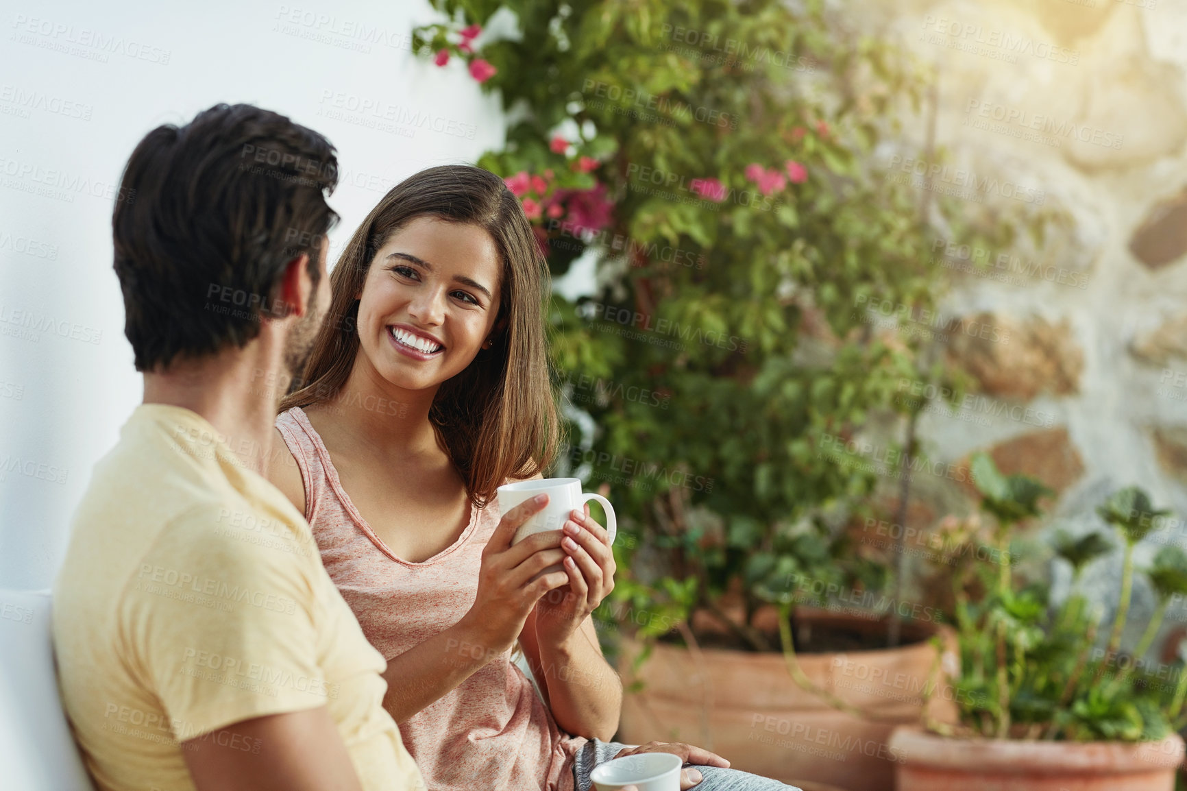 Buy stock photo Couple, happy and coffee together in outdoor with love, care and bonding for loyalty in home. Smile, man and woman on backyard patio with espresso drink for morning peace, wellness and partnership