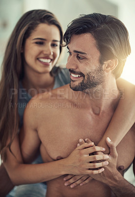 Buy stock photo Cropped shot of an affectionate young couple sitting down in their bedroom