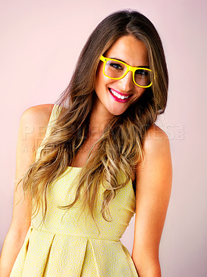 Buy stock photo Studio shot of a young woman wearing colorful glasses against a pink background