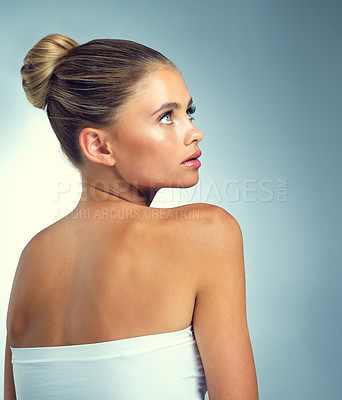 Buy stock photo Relax, thinking and woman in studio with beauty, natural skincare and luxury cosmetics from back. Dermatology, facial care and girl with mockup space, makeup and healthy skin on blue background.