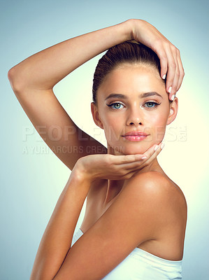 Buy stock photo Studio portrait of an attractive young woman posing against a gray background