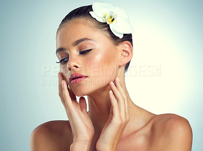 Buy stock photo Studio shot of an attractive young woman posing against a gray background