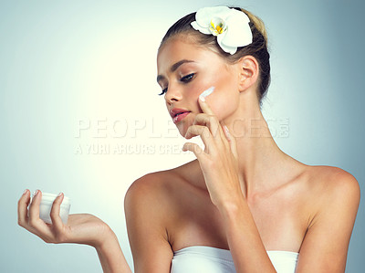 Buy stock photo Studio shot of an attractive young woman posing against a gray background