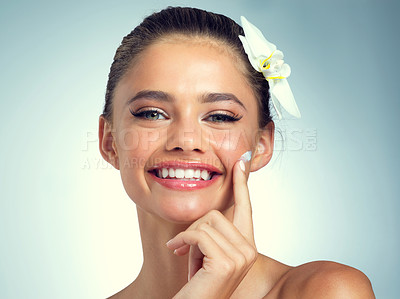 Buy stock photo Studio, portrait and woman with flower for skincare, anti aging and rich mineral of magnesium for wellness. Female person, results and smile for beauty treatment with orchid, plant or blue background