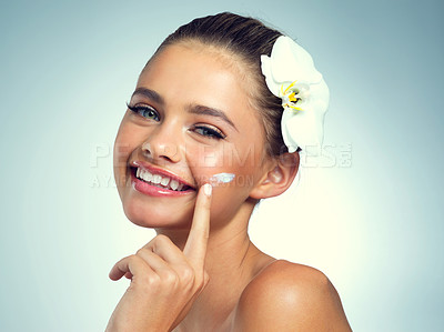 Buy stock photo Studio, portrait and woman with cream for skincare, anti aging and rich mineral of magnesium for wellness. Female model, results and lotion for beauty treatment with orchid, flower or blue background