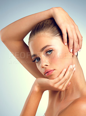 Buy stock photo Studio portrait of an attractive young woman posing against a gray background