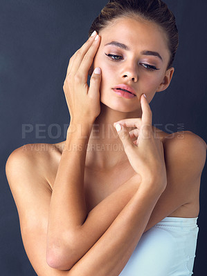 Buy stock photo Elegant, thinking and woman with skincare for beauty on black background with foundation, shine or glow. Idea, confident model or face of girl in studio with cosmetics, hands or makeup results