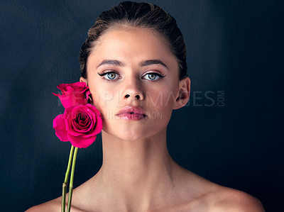 Buy stock photo Flower, portrait and girl with skincare for beauty on black background with foundation, shine or glow. Floral, confident model or proud woman in studio with cosmetics, hydration or makeup for results