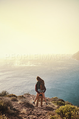 Buy stock photo Rearview shot of a young man piggybacking his girlfriend during their hike in the mountains