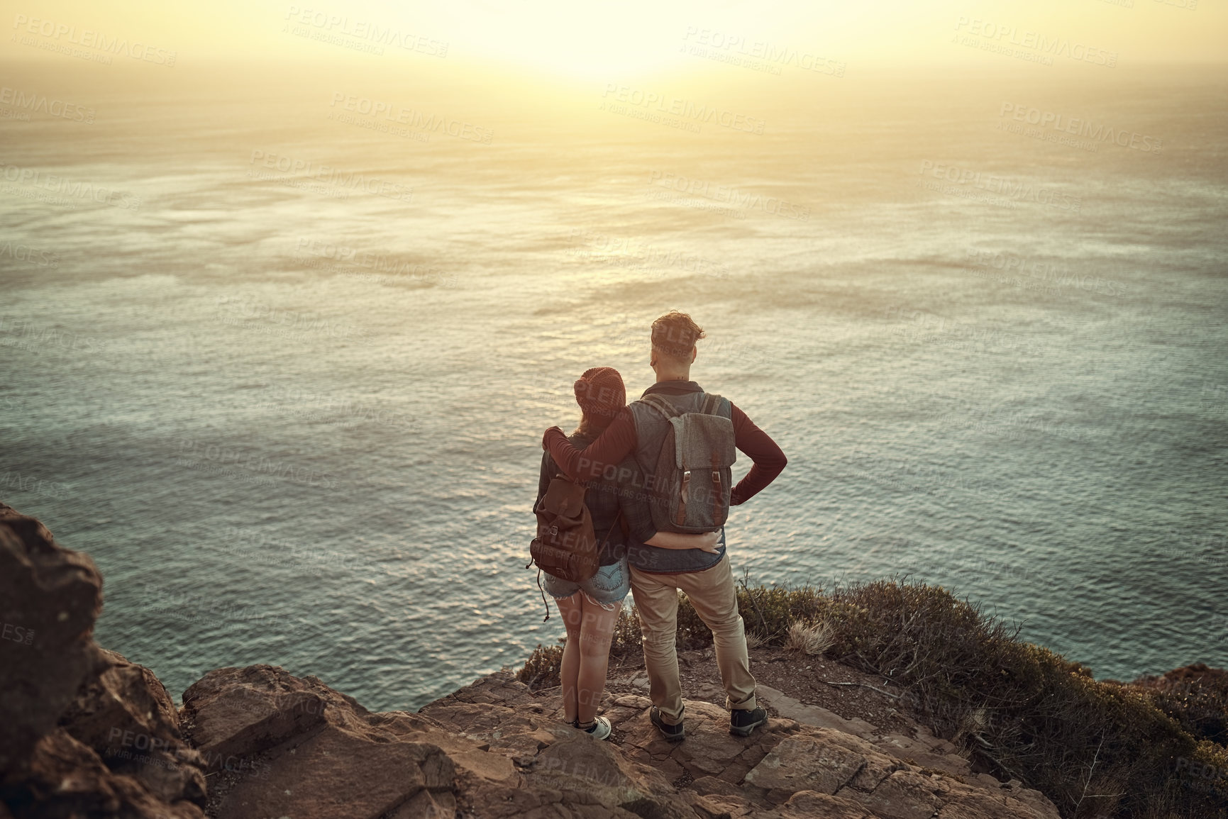 Buy stock photo Back view, man and woman on mountain for hug, support and adventure or travel with love. Tourists, couple and mockup in nature for vacation or holiday together and sunrise in morning for summer