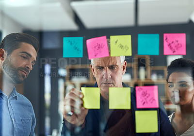 Buy stock photo Shot of a group of colleagues having a brainstorming session in a modern office