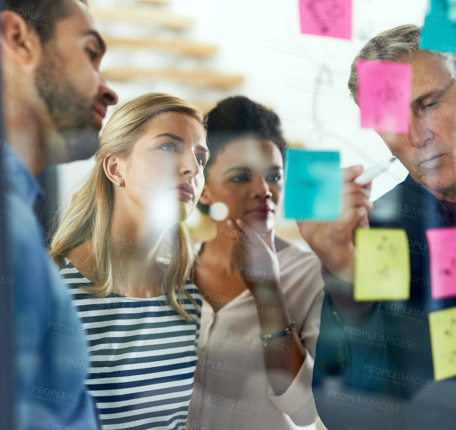 Buy stock photo Shot of a group of colleagues having a brainstorming session in a modern office