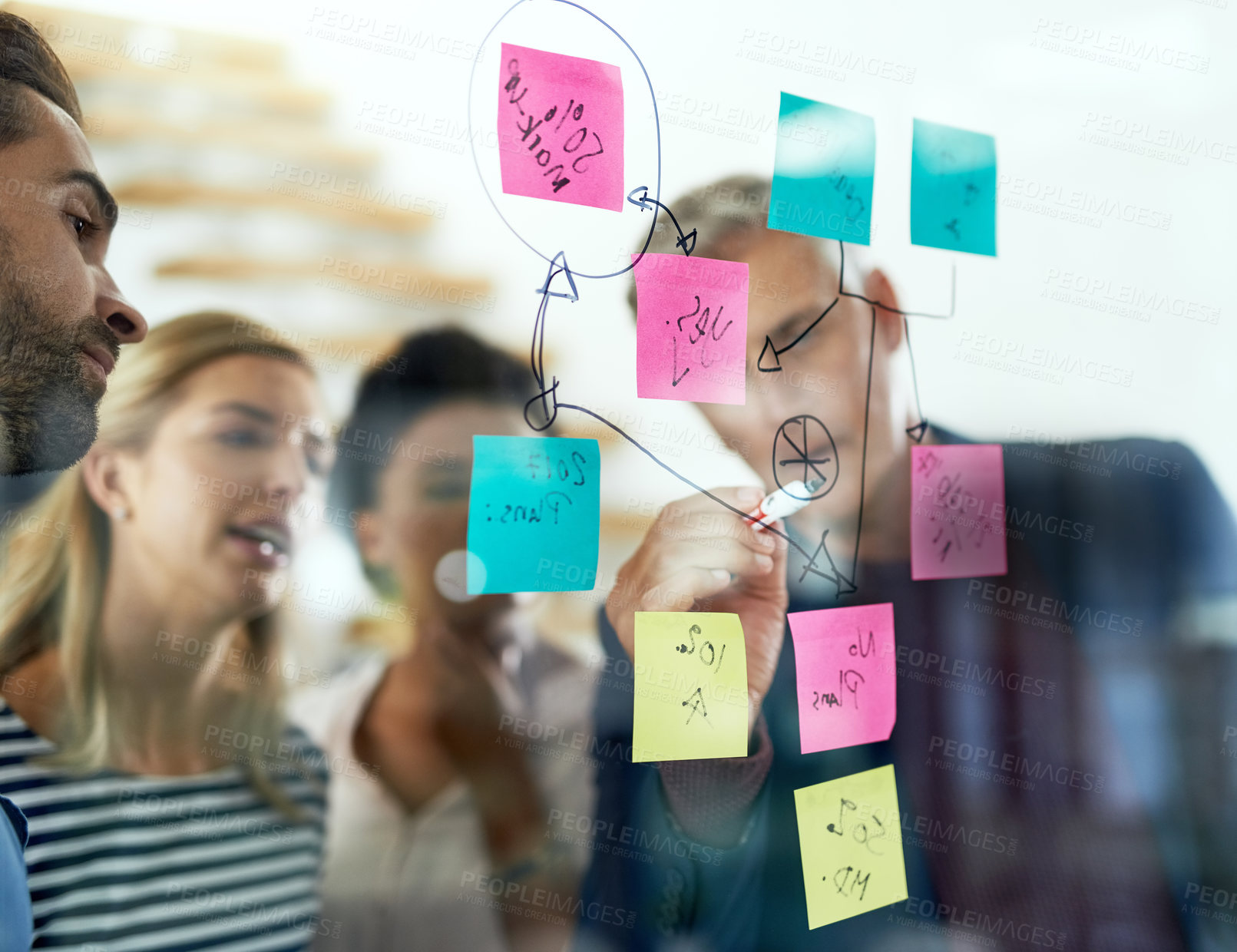 Buy stock photo Shot of a group of colleagues having a brainstorming session in a modern office