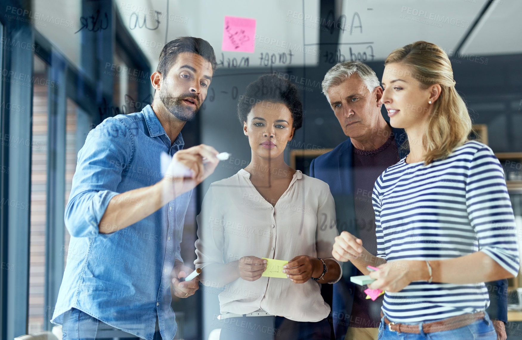 Buy stock photo Shot of a group of colleagues having a brainstorming session in a modern office