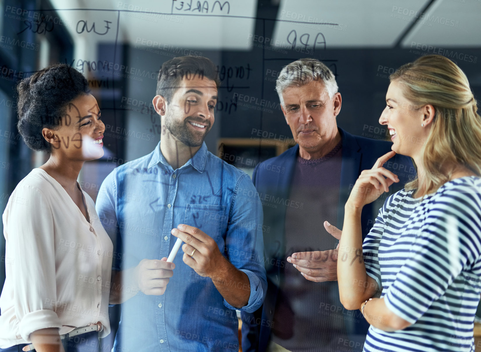 Buy stock photo Shot of a group of colleagues having a brainstorming session in a modern office