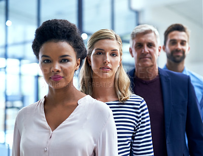 Buy stock photo Portrait of a team of colleagues standing together in a row at work