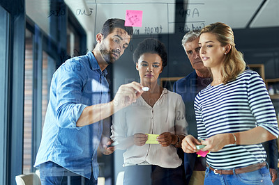 Buy stock photo Shot of a group of colleagues having a brainstorming session in a modern office