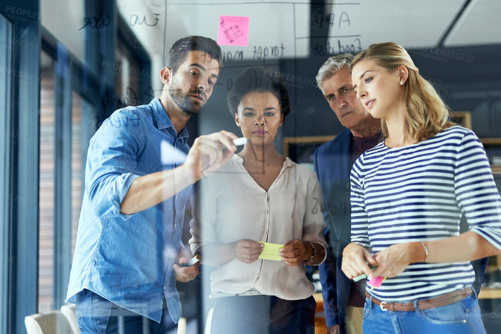 Buy stock photo Man, team and writing on glass at startup for notes, brainstorming and ideas for app in office. Business people, presentation and diversity in collaboration, thinking and board at web design agency