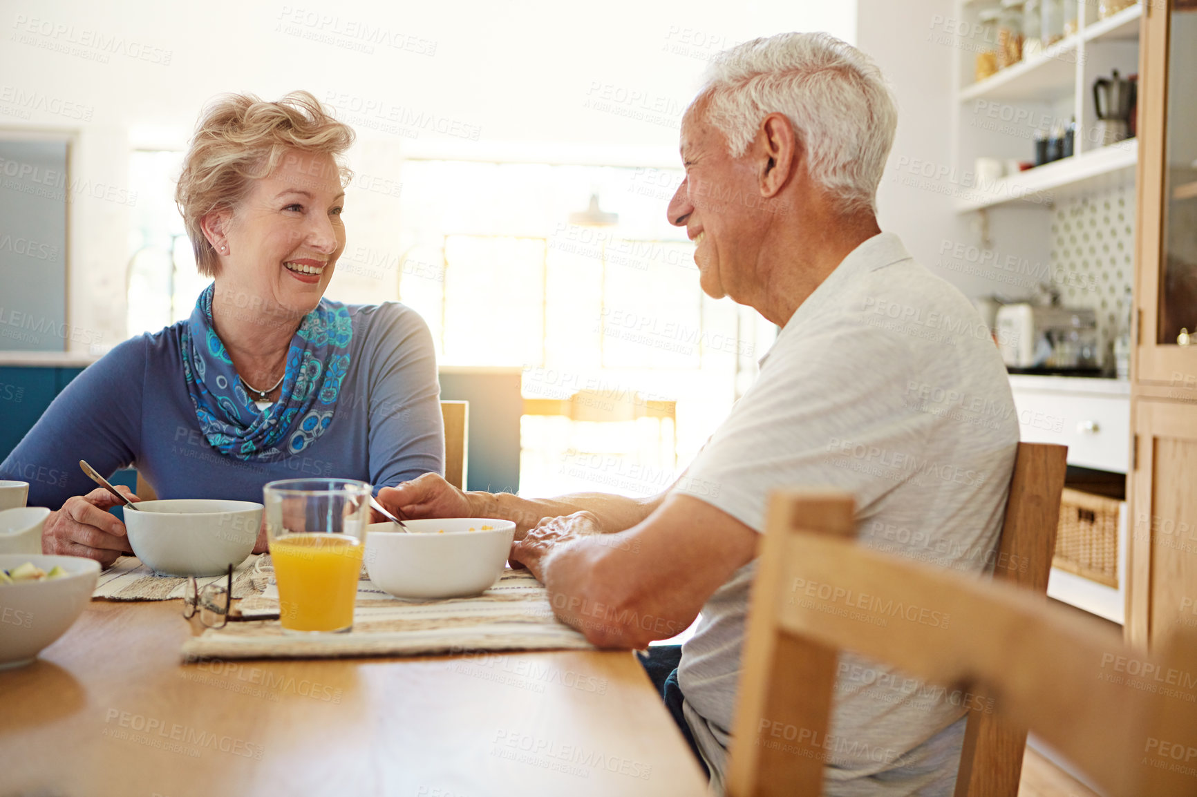 Buy stock photo Elderly, couple and talking with eating at breakfast in dining room for nutrition, healthy meal and retirement. Senior, people and smile in home with conversation, relax or morning routine at table