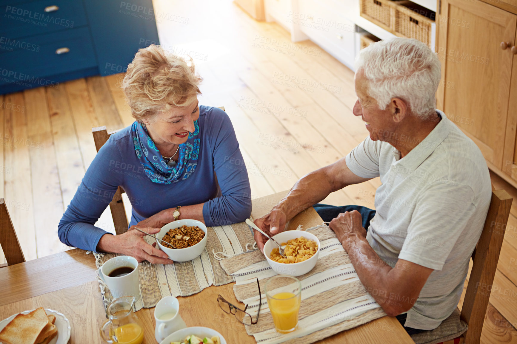 Buy stock photo Elderly, couple or happy with eating at breakfast in dining room for nutrition, healthy meal or retirement. Senior, people or porridge in home with conversation, relax or morning routine from above