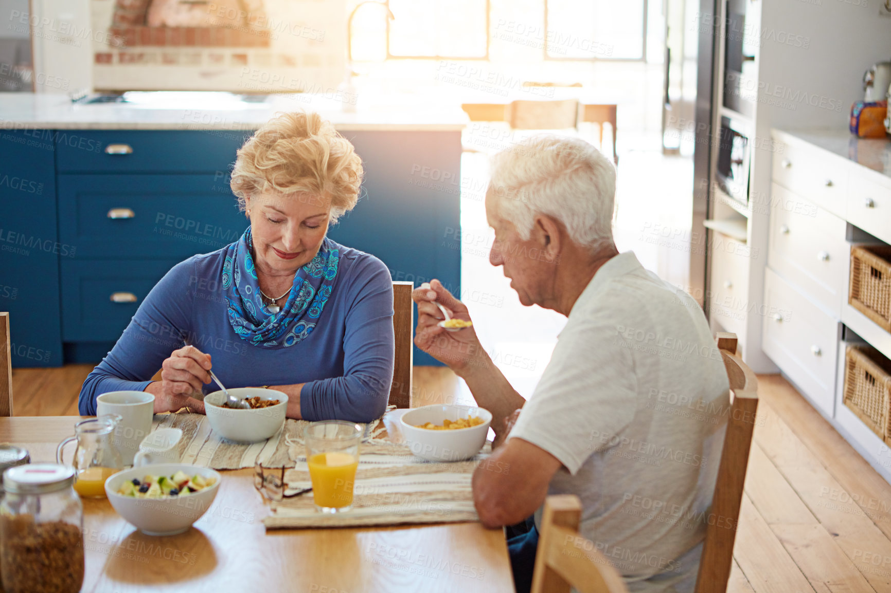 Buy stock photo Senior, couple or talking with eating at breakfast in dining room for nutrition, healthy meal or retirement. Elderly, people or porridge in home with conversation, relax or morning routine at table