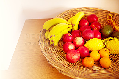 Buy stock photo High angle shot of a basket with various fruits on an empty table