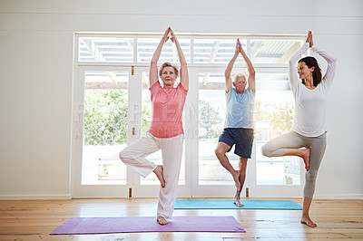 Buy stock photo Full length shot of a female yoga instructor working with a senior couple
